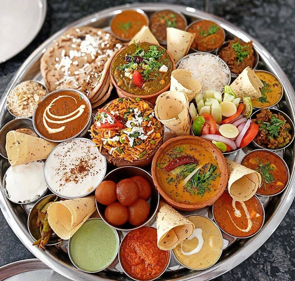 An Indian thali with breads, rice and a colourful selection of vegetarian dishes at Highway Xpress